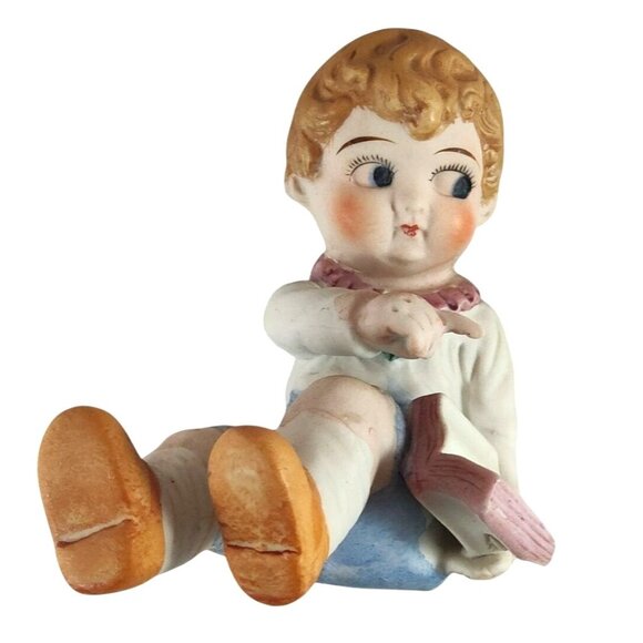 Vintage Bisque Piano Baby Figurine Holding Book Marked 122 Made In Japan - Picture 1 of 12
